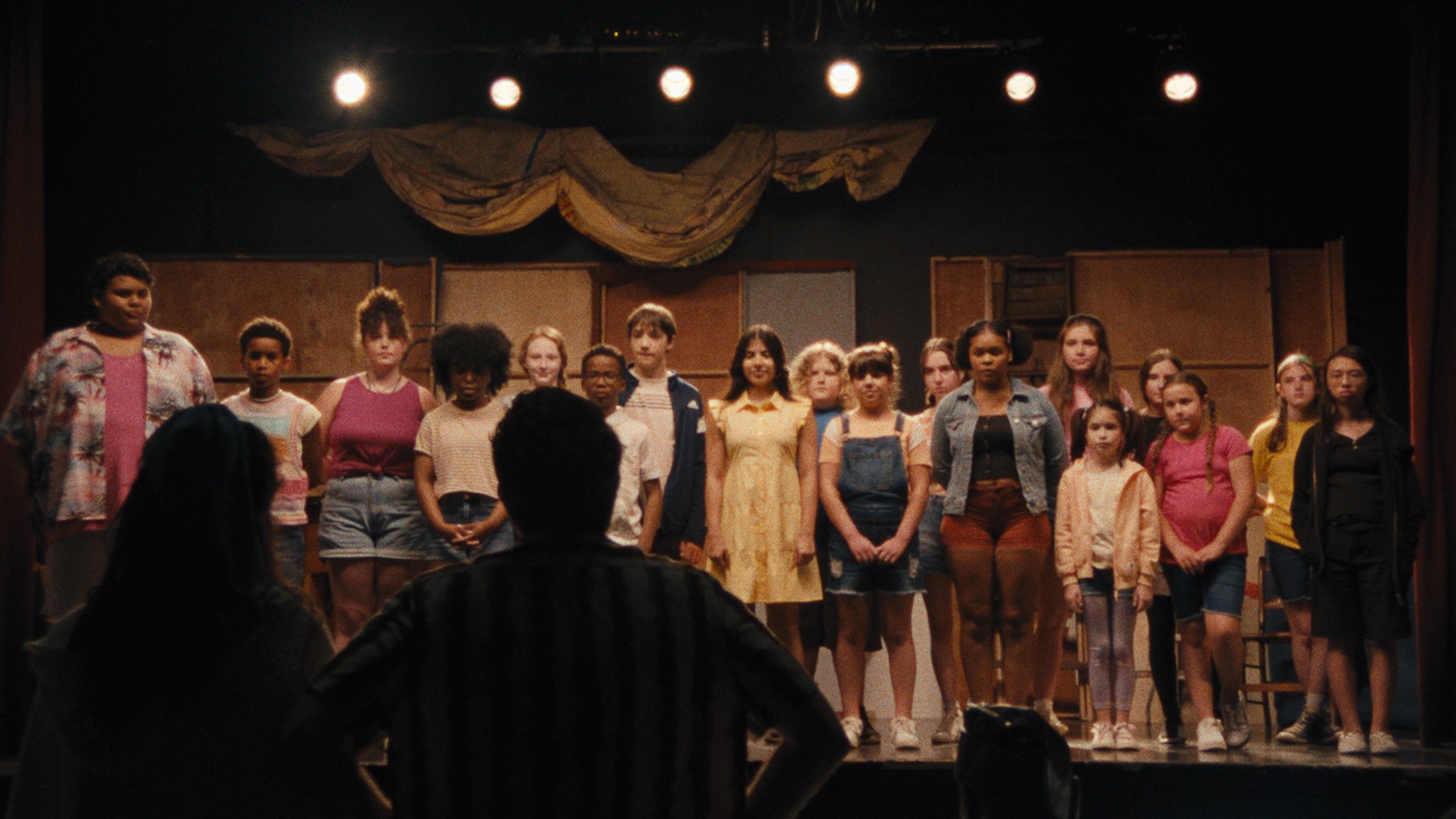 Donovan Colan with the Theater Camp ensemble on stage